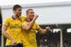 LONDON, ENGLAND - AUGUST 24: Lukas Podolski of Arsenal (R) celebrates scoring his side's third goal with team mate Olivier Giroud during the Barclays Premier League match between Fulham and Arsenal at Craven Cottage on August 24, 2013 in London, England.