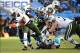 Dec 15, 2013; Charlotte, NC, USA; New York Jets quarterback Geno Smith (7) is sacked by Carolina Panthers cornerback Captain Munnerlyn (41) and defensive tackle Dwan Edwards (92) as middle linebacker Luke Kuechly (59) helps defend in the first quarter at