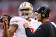 GLENDALE, AZ - DECEMBER 29: (L-R) Colin Kaepernick #7 of the San Francisco 49ers talks with head coach Jim Harbaugh on the sidelines against the Arizona Cardinals during a game at University of Phoenix Stadium on December 29, 2013 in Glendale, Arizona.