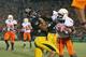 COLUMBIA, MO - OCTOBER 11: Dez Bryant #1 of the Oklahoma State Cowboys stiff-arms Castine Bridges #21 of the Missouri Tigers on October 11, 2008 at Memorial Stadium in Columbia, Missouri. (Photo by G. Newman Lowrance/Getty Images)