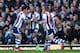 LONDON, ENGLAND - DECEMBER 28: Nicolas Anelka of West Brom touches his sleeve as he celebrates scoring their first goal during the Barclays Premier League match between West Ham United and West Bromwich Albion at Boleyn Ground on December 28, 2013 in Lon