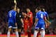 LIVERPOOL, ENGLAND - JANUARY 01: Luis Suarez of Liverpool smiles as he receives a yellow card from Referee Craig Pawson during the Barclays Premier League match between Liverpool and Hull City at Anfield on January 1, 2014 in Liverpool, England. (Photo b