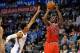 Dec 19, 2013; Oklahoma City, OK, USA; Chicago Bulls shooting guard Jimmy Butler (21) shoots the ball while defended by Oklahoma City Thunder shooting guard Jeremy Lamb (11) during the second quarter at Chesapeake Energy Arena. Mandatory Credit: Mark D. Sm