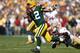 GREEN BAY, WI - SEPTEMBER 9: Aaron Rodgers #12 of the Green Bay Packers runs away from pursuit by Aldon Smith #99 of the San Francisco 49ers in the first half of the game at Lambeau Field on September 9, 2012 in Green Bay, Wisconsin. (Photo by Joe Robbins
