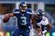 SEATTLE, WA - AUGUST 17: Quarterback Russell Wilson #3 of the Seattle Seahawks is tackled by linebacker Wesley Woodyard #52 of the Denver Broncos at CenturyLink Field on August 17, 2013 in Seattle, Washington. (Photo by Otto Greule Jr/Getty Images)