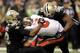 NEW ORLEANS, LA - DECEMBER 29: Mike Glennon #8 of the Tampa Bay Buccaneers is sacked by Junior Galette #93 and Parys Harrelson #98 of the New Orleans Saints during a game at the Mercedes-Benz Superdome on December 29, 2013 in New Orleans, Louisiana. New