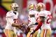 GLENDALE, AZ - DECEMBER 29: Carlos Rogers #22 of the San Francisco 49ers celebrates with teammates Tramaine Brock #26 and Tarell Brown #25 after a turnover on downs in the third quarter against the Arizona Cardinals during a game at University of Phoen