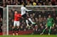 MANCHESTER, ENGLAND - JANUARY 01: Emmanuel Adebayor of Tottenham Hotspur scores the opening goal during the Barclays Premier League match between Manchester United and Tottenham Hotspur at Old Trafford on January 1, 2014 in Manchester, England. (Photo