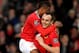 MANCHESTER, ENGLAND - DECEMBER 26: Dimitar Berbatov of Manchester United celebrates scoring with team mate Patrice Evra (L) during the Barclays Premier League match between Manchester United and Wigan Athletic at Old Trafford on December 26, 2011 in Manc