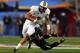 GLENDALE, AZ - JANUARY 01: Quarterback Blake Bortles #5 of the UCF Knights is tackled by linebacker Eddie Lackey #5 of the Baylor Bears during the Tostitos Fiesta Bowl at University of Phoenix Stadium on January 1, 2014 in Glendale, Arizona. (Photo by Ro