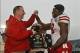 Jan 1, 2014; Jacksonville, FL, USA; Nebraska Cornhuskers head coach Bo Pelini reacts as he hands the Gator Bowl most valuable player trophy to wide receiver Quincy Enunwa (18) after their game against the Georgia Bulldogs at EverBank Field. The Nebraska C