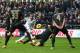 SWANSEA, WALES - JANUARY 01: Ashley Williams of Swansea City has a shot blocked by Edin Dzeko of Manchester City during the Barclays Premier League match between Swansea City and Manchester City at the Liberty Stadium on January 1, 2014 in Swansea, Wales