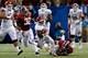 NEW ORLEANS, LA - JANUARY 02: Roy Finch #22 of the Oklahoma Sooners is tackled by Adrian Hubbard #42 of the Alabama Crimson Tide during the Allstate Sugar Bowl at the Mercedes-Benz Superdome on January 2, 2014 in New Orleans, Louisiana. (Photo by Kevin