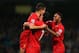 MANCHESTER, ENGLAND - DECEMBER 26: Luis Suarez (C) and Raheem Sterling (R) of Liverpool congratulate goalscorer Philippe Coutinho during the Barclays Premier League match between Manchester City and Liverpool at Etihad Stadium on December 26, 2013 in Man