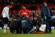 MANCHESTER, ENGLAND - JANUARY 01: Emmanuel Adebayor of Tottenham Hotspur receives treatment for an injury during the Barclays Premier League match between Manchester United and Tottenham Hotspur at Old Trafford on January 1, 2014 in Manchester, England.
