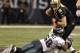 New Orleans Saints quarterback Drew Brees dodges Philadelphia Eagles linebacker Trent Cole during an NFL NFC divisional playoff game on January 13, 2007 in the Superdome in New Orleans, Louisiana. The Saints won 27 - 24. (Photo by Al Messerschmidt/Ge