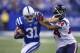 INDIANAPOLIS, IN - DECEMBER 15: Donald Brown #31 of the Indianapolis Colts runs the brown and give a stiff arm to Johnathan Joseph #24 of the Houston Texans at Lucas Oil Stadium on December 15, 2013 in Indianapolis, Indiana. (Photo by Michael Hickey/Getty