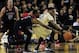 Dec 31, 2013; Orlando, FL, USA; UCF Knights guard Brandon Goodwin (22) and Louisville Cardinals guard Russ Smith (2) reach for the ball in the first half as the Louisville Cardinals face the UCF Knights at UCF Arena. Mandatory Credit: David Manning-USA TO