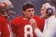 NOV 1987: SAN FRANCISCO QUARTERBACK JOE MONTANA TALKS WITH HEAD COACH BILL WALSH, AS BACKUP QUARTERBACK STEVE YOUNG LISTENS, DURING THE 49ERS GAME AT CANDLESTICK PARK IN SAN FRANCISCO, CALIFORNIA. Mandatory Credit: Otto Greule/ALLSPORT
