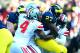 Nov 30, 2013; Ann Arbor, MI, USA; Michigan Wolverines running back Derrick Green (27) is tackled by Ohio State Buckeyes safety C.J. Barnett (4) during the first quarter at Michigan Stadium. Mandatory Credit: Andrew Weber-USA TODAY Sports