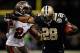 NEW ORLEANS, LA - DECEMBER 16: Mark Ingram #28 of the New Orleans Saints is pushed out of bounds by Mark Barron #24 of the Tampa Bay Buccaneers at the Mercedes-Benz Superdome on December 16, 2012 in New Orleans, Louisiana. The Saints defeated the Buccs