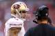 GLENDALE, AZ - DECEMBER 29: (L-R) Colin Kaepernick #7 of the San Francisco 49ers talks with head coach Jim Harbaugh on the sidelines against the Arizona Cardinals during a game at University of Phoenix Stadium on December 29, 2013 in Glendale, Arizona.