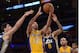 Jan 3, 2014; Los Angeles, CA, USA; Los Angeles Lakers guard Kendall Marshall (12) is defended by Utah Jazz center Enes Kanter (0) and guard Diante Garrett (8) at Staples Center. Mandatory Credit: Kirby Lee-USA TODAY Sports