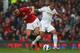 MANCHESTER, ENGLAND - MAY 12: Wayne Routledge of Swansea City tangles with Rio Ferdinand of Manchester United during the Barclays Premier League match between Manchester United and Swansea City at Old Trafford on May 12, 2013 in Manchester, England. (Ph