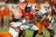 MIAMI GARDENS, FL - JANUARY 03: Braxton Miller #5 of the Ohio State Buckeyes is sacked in the second quarter by Vic Beasley #3 and Stephone Anthony #42 of the Clemson Tigers during the Discover Orange Bowl at Sun Life Stadium on January 3, 2014 in Miami G