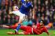 LIVERPOOL, ENGLAND - JANUARY 05: James Wesolowski of Oldham is tackled by Luis Alberto of Liverpool during the Budweiser FA Cup third round match between Liverpool and Oldham Athletic at Anfield on January 5, 2014 in Liverpool, England. (Photo by Clive
