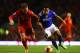 LIVERPOOL, ENGLAND - JANUARY 05: Korey Smith of Oldham takes on Lucas of Liverpool during the Budweiser FA Cup third round match between Liverpool and Oldham Athletic at Anfield on January 5, 2014 in Liverpool, England. (Photo by Clive Mason/Getty Images