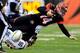 CINCINNATI, OH - JANUARY 05: Quarterback Andy Dalton #14 of the Cincinnati Bengals is sacked by outside linebacker Jarret Johnson #96 of the San Diego Chargers during a Wild Card Playoff game at Paul Brown Stadium on January 5, 2014 in Cincinnati, Ohio.