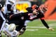 CINCINNATI, OH - JANUARY 05: Quarterback Andy Dalton #14 of the Cincinnati Bengals is sacked by outside linebacker Jarret Johnson #96 of the San Diego Chargers during a Wild Card Playoff game at Paul Brown Stadium on January 5, 2014 in Cincinnati, Ohio.