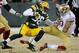 Jan 5, 2014; Green Bay, WI, USA; Green Bay Packers cornerback Tramon Williams (38) is tackled by San Francisco 49ers quarterback Colin Kaepernick (7) after intercepting a pass in the second quarter during the 2013 NFC wild card playoff football game at