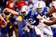 Jan 4, 2014; Indianapolis, IN, USA; Indianapolis Colts quarterback Andrew Luck (12) dives into the end zone for a touchdown during the fourth quarter of the 2013 AFC wild card playoff football game against the Kansas City Chiefs at Lucas Oil Stadium. Mand