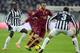 TURIN, ITALY - JANUARY 05: Giorgio Chiellini of FC Juventus #3 and Daniele De Rossi of AS Roma compete for the ball during the Serie A match between Juventus and AS Roma at Juventus Arena on January 5, 2014 in Turin, Italy. (Photo by Claudio Villa/Getty