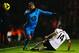 LONDON, ENGLAND - DECEMBER 04: Aaron Lennon (L) of Tottenham Hotspur is challenged by Giorgos Karagounis (R) of Fulham during the Barclays Premier League match between Fulham and Tottenham Hotspur at Craven Cottage on December 4, 2013 in London, England.