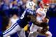 INDIANAPOLIS, IN - JANUARY 04: Outside linebacker Robert Mathis #98 of the Indianapolis Colts forces a fumble by quarterback Alex Smith #11 of the Kansas City Chiefs during a Wild Card Playoff game at Lucas Oil Stadium on January 4, 2014 in Indianapolis,