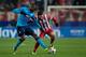 MADRID, SPAIN - DECEMBER 11: Jackson Martinez (L) of FC Porto competes for the ball with Arda Turan (R) of Atletico de Madrid during the UEFA Champions League Group G match at Vicente Calderon Stadium on December 11, 2013 in Madrid, Spain. (Photo by Go