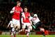 LONDON, ENGLAND - JANUARY 04: Emmanuel Adebayor of Spurs miscues a shot on goal as Per Mertesacker (L) and Laurent Koscielny (C) of Arsenal close in and during the Budweiser FA Cup third round match between Arsenal and Tottenham Hotspur at Emirates Stadi