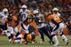 DENVER, CO - DECEMBER 12: Ryan Mathews #24 of the San Diego Chargers is tackled by Wesley Woodyard #52 and Chris Harris #25 of the Denver Broncos in the second quarter at Sports Authority Field at Mile High on December 12, 2013 in Denver, Colorado. (Ph