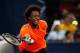 SHANGHAI, CHINA - OCTOBER 10: Gael Monfils of France returns a shot to Roger Federer of Switzerland during day four of the Shanghai Rolex Masters at the Qi Zhong Tennis Center on October 10, 2013 in Shanghai, China. (Photo by Lintao Zhang/Getty Images)