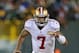 GREEN BAY, WI - JANUARY 05: Colin Kaepernick #7 of the San Francisco 49ers runs for a first down against the Green Bay Packers during an NFC Wild Card Playoff game at Lambeau Field on January 5, 2014 in Green Bay, Wisconsin. The 49ers defeated the Packers