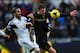 SWANSEA, WALES - JANUARY 01: Swansea defender Chico Flores (c) challenges Edin Dzeko during the Barclays Premier League match between Swansea City and Manchester City at Liberty Stadium on January 1, 2014 in Swansea, Wales. (Photo by Stu Forster/Getty