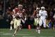 Jan 6, 2014; Pasadena, CA, USA; Florida State Seminoles wide receiver Rashad Greene (80) runs with the ball after a catch past Auburn Tigers defensive end Dee Ford (30) during the second half of the 2014 BCS National Championship game at the Rose Bowl.