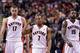 Jan 1, 2014; Toronto, Ontario, CAN; Toronto Raptors point guard Kyle Lowry (7) and center Jonas Valanciunas (17) and power forward Amir Johnson (15) react to a play during the fourth quarter of a game at the Air Canada Centre. Toronto won the game 95-82.