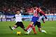 MADRID, SPAIN - DECEMBER 15: Diego Costa (R) of Club Atletico de Madrid shoots past Victor Ruiz of Valencia CF to score Atletico's opening goal during the La Liga match between Club Atletico de Madrid and Valencia CF at Vicente Calderon Stadium on Decemb