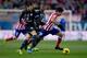 MADRID, SPAIN - DECEMBER 21: Diego Costa of Atletico de Madrid (R) competes for the ball with Nikos Karabelas (L) of Levante UD during the La Liga match between Club Atletico de Madrid and Levante UD at Vicente Calderon Stadium on December 21, 2013 in Mad