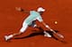 PARIS, FRANCE - JUNE 07: Novak Djokovic of Serbia plays a backhand during the men's singles semi-final match against Rafael Nadal of Spain on day thirteen of the French Open at Roland Garros on June 7, 2013 in Paris, France. (Photo by Matthew Stockman/G