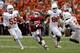 DALLAS, TX - OCTOBER 13: Brennan Clay #24 of the Oklahoma Sooners carries the ball against Dalton Santos #55 of the Texas Longhorns, Cedric Reed #88 of the Texas Longhorns and Mykkele Thompson #2 of the Texas Longhorns at Cotton Bowl on October 13, 2012